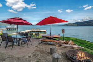 Waterfront set up includes tables, lounge seats and a firepit for those summer evenings