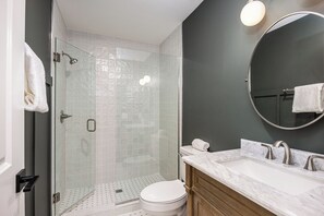 The bathroom features a walk-in shower.