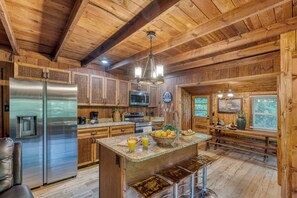 Fully equipped kitchen with an island counter and barstool seating.