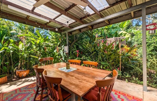 Outdoor dining space under full length verandah