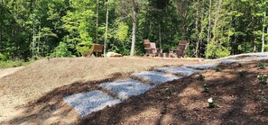 Backyard: Fire Pit with 4 Adirondack Chairs and a Bench.
