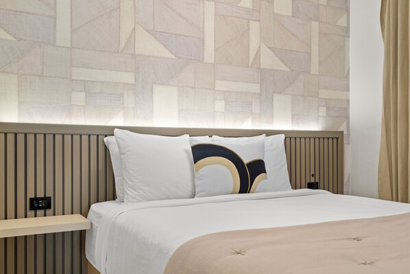 Drift off into dreamland on our plush bed, adorned with soft linens and cozy pillows.








