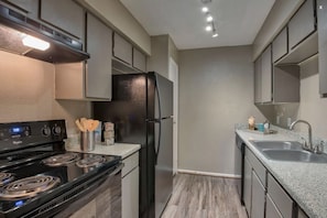 Skip eating out and make some meals at home. With ample storage, this kitchen boasts a full size oven, refrigerator, stovetop, dishwasher, and all the essentials needed for daily use.
