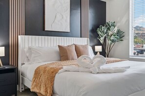 Wake up to stunning views in our cozy bedroom, complete with a comfortable bed, desk area, and a touch of greenery.