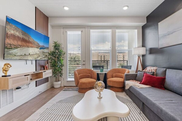 Enjoy the perfect balance of light and nature in our living room, featuring a bamboo plant and artful touches.