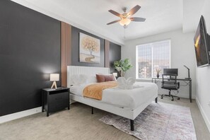 Unwind in this stylish bedroom with a king-sized bed, scenic window views, and a desk area for work or leisure.
