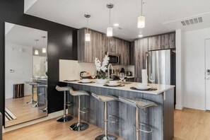 Relax and enjoy your meals at the bar counter in our well-appointed kitchen, featuring a dishwasher and high stools.