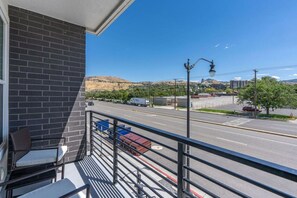 Savor breathtaking views from our veranda, complete with cozy chairs and a stylish coffee table.