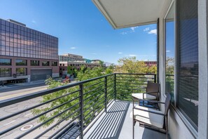 Relax on the veranda with two cozy chairs and a coffee table, perfect for morning coffee.