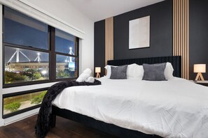 Our bedroom offers a perfect escape, with a king-sized bed, soothing plant, and convenient bedside tables.