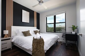 Unwind in our cozy bedroom, complete with a huge comfy bed, smart TV, and a stunning tower view from the large window.
