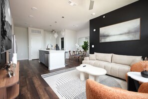 Relax in a stylish living room with a cozy long sofa, single chairs, and artistic accents that make it unique.
