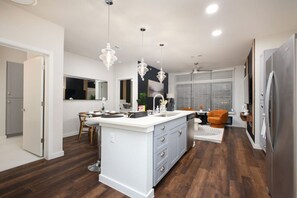 Create culinary magic in our kitchen, where a bar counter and sink meet a full set of amenities and the beauty of mini plants.