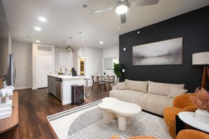 Bright and comfortable, our living room features a large sofa, big windows, and small artistic decorations for a unique ambiance.