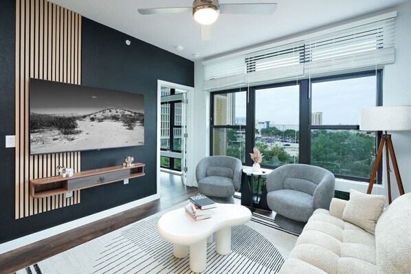 Experience comfort and charm in our living room, with cozy chairs, a comfy sofa, and artistic decor throughout.