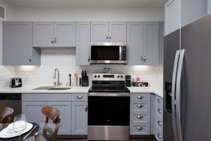 Experience the convenience of a fully-stocked kitchen, coffee maker, and a fresh touch of mini plants.