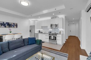Relax on the comfy couch, enjoy the TV, or get some work done at the dedicated workstation in the open-concept living area.