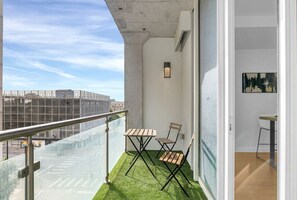 Step outside and relax on the balcony, complete with comfortable seating for two.
