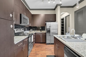 Cook up a storm in the fully equipped kitchen, complete with a stylish bar counter for casual dining.