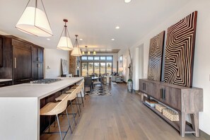 Modern and high end appointed chefs kitchen with a massive island and additional seating