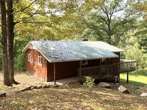 Sheltered under mature sugar maples, this is a view of cottage from driveway