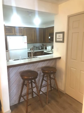 Kitchen w/ drip coffee pot, toaster, pots, pans