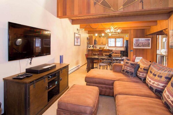 Living room w/ DVD player, Youtube TV (and Amazon Firesticks), wood burning fireplace and balcony access w/ BBQ grill