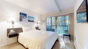 Main bedroom: Queen bedroom with balcony access, TV, and en suite bathroom