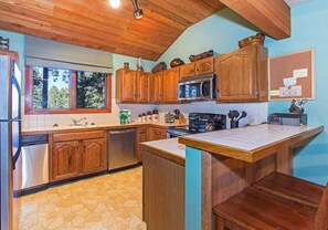 Kitchen w/ toaster, drip coffee pot, blender, slow cooker, pots, pans and more