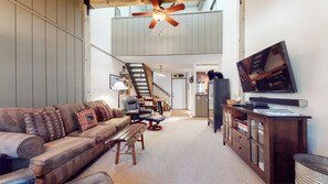 Cozy and spacious living area with TV and fireplace