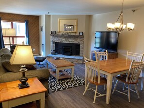 Newly updated living room with fireplace and TV