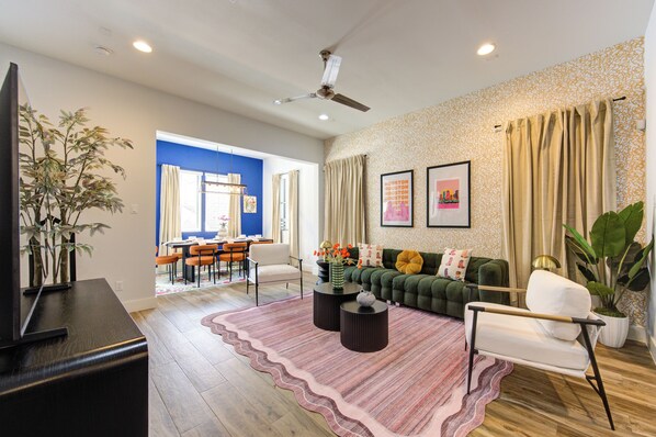 The living room is in between the dining area and kitchen
