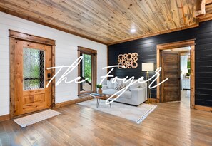 A warm welcome awaits you as you step into this bright and inviting foyer, featuring wood accents and a cozy vibe.