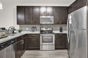 Discover the heart of the home in this stylish kitchen, complete with gleaming granite countertops and sleek appliances.
