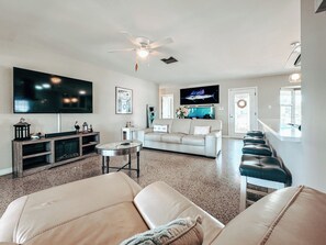 Relax in style! Spacious living room opens to kitchen and Florida room seating.

