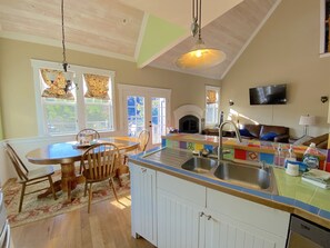 View from kitchen of breakfast nook, the bar, and the great room. Open, spacious and bright. Prepare gourmet meals while still visiting with guests. Doors lead to outdoor deck with seating and bbq.