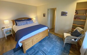 The Primary bedroom features a comfortable queen size bed, its own personal bathroom and dressing room. 