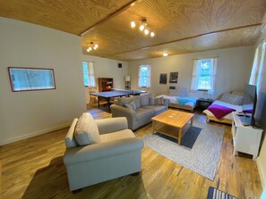 The bonus living room features a comfy, luxury chair and pullout couch, along with two twin beds that can be pushed together for a larger bed create extra sleeping spaces. Fun for the whole family with a ping pong table and other games