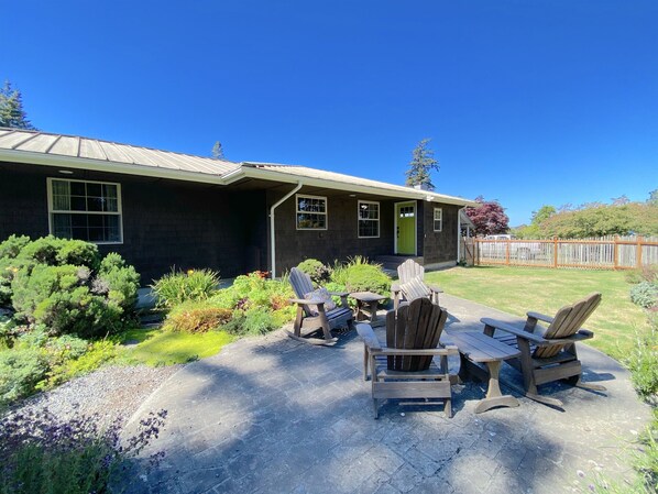 The front of the home features a fully fenced front yard with a gorgeous fragrant garden and seating area. This is the perfect place for morning coffee and bird watching. 