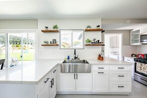 Modern kitchen space, equipped to accommodate your cooking needs. 