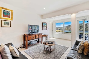 Lounge room with large Smart TV , Netflix and DVD with lots of movie, for when your not looking at the view.