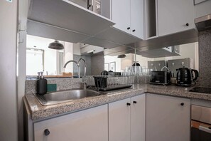 Modern kitchen with sleek appliances and ample counter space, perfect for preparing meals during your stay.