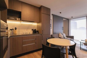 Experience modern comfort in this sleek kitchen and cozy living area, perfect for relaxing after a day of exploring.