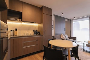 Experience modern comfort in this sleek kitchen and cozy living area, perfect for relaxing after a day of exploring.