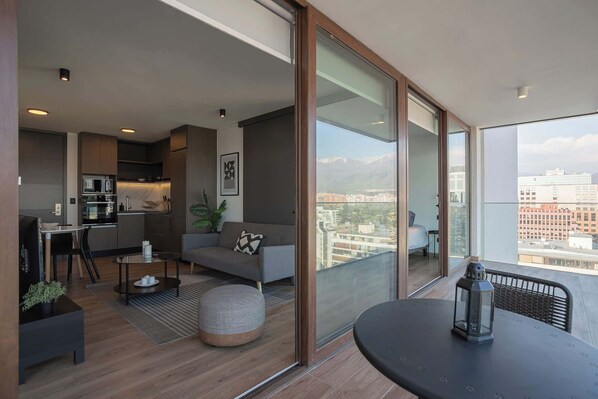 Experience urban living with stunning city views from this stylish apartment featuring a cozy living area and modern kitchen.