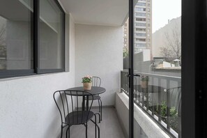 Enjoy a peaceful morning coffee on your private balcony with city views.