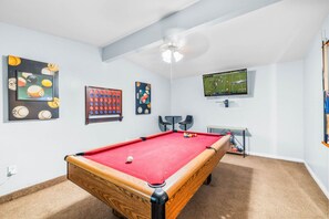 Challenge your friends to a game of pool in this fun entertainment room equipped with a Smart TV, Large connect 4 and board games!