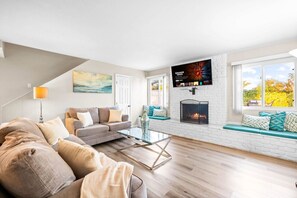 Relax in this spacious and inviting living room, part of a modern 4-bedroom retreat designed for comfort and style — perfect for your next vacation!