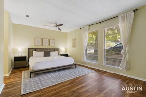 Upstairs king bedroom with luxury linens, bathroom, and closet