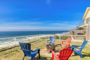 Relax by the firepit with ocean views! Perfect spot for evening chats.